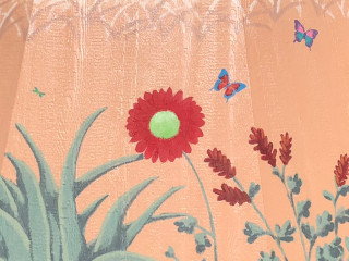 painted red meadow flowers and colorful butterflies on a tan wooden wall